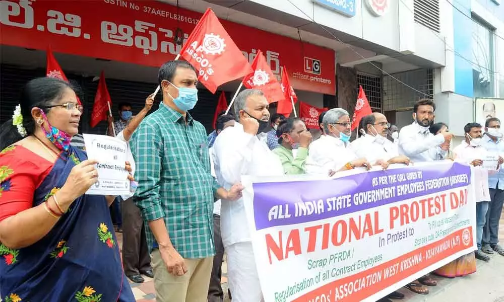 Members of NGOs Association taking part in a protest in Vijayawada on Friday