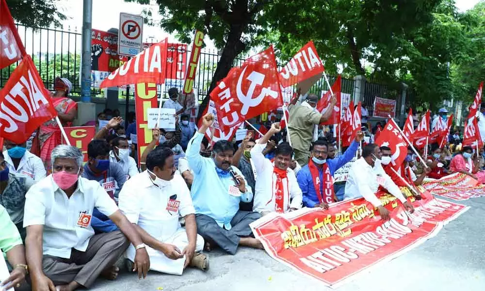 CITU and AITUC leaders staging dharna against policies of Union government, in Tirupati on Friday  	photo: Kalakata Radhakrishna