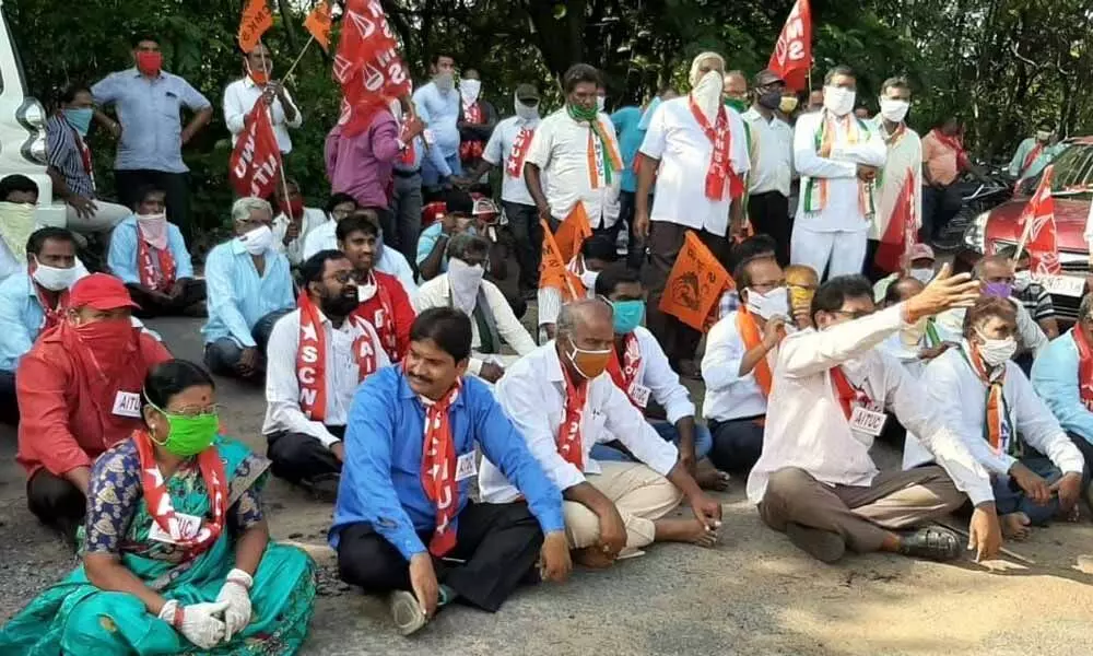 Trade union leaders staging a protest in front of the corporate office in Kothagudem on Friday