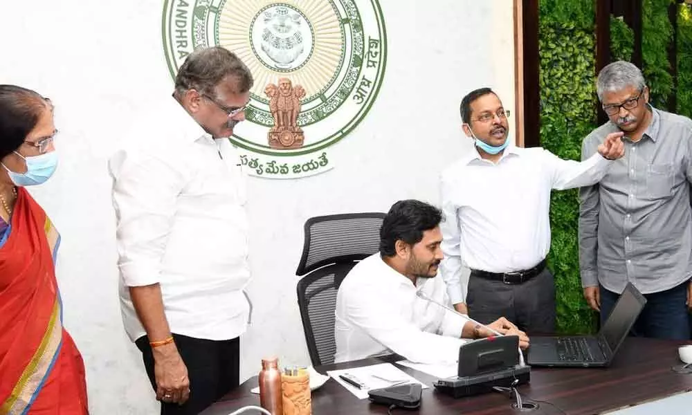 CM Y S Jagan Mohan Reddy launching Andhra Pradesh Corporation for Outsourced Services through a video conference at his camp office at Tadepalli on Friday. Minister for Municipal Administration and Urban Development Botcha Satyanarayana, Chief Secretary Nilam Sawhney and others are seen