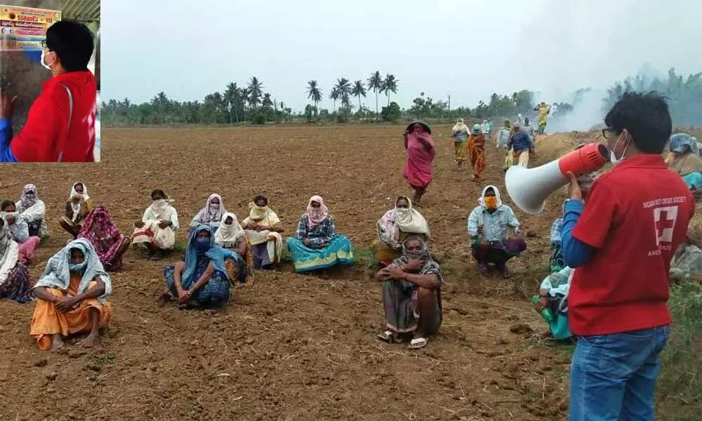 An IRCS volunteer creating awareness among farm workers on Covid-19 preventive measures