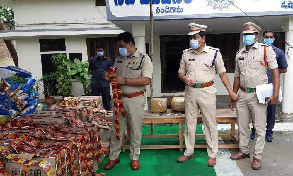Superintendent of Police M Ravindranath Babu with seized gutka packets at the Nandigama police station on Sunday