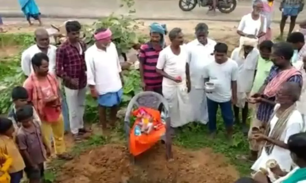 Villagers burying the monkey on the outskirts of Sitarampalli on Sunday