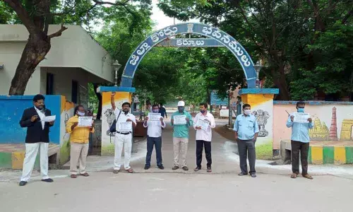 Demanding immediate release of Rs.100 crore welfare fund, advocates stage a protest in front of District Court in Kurnool on Monday