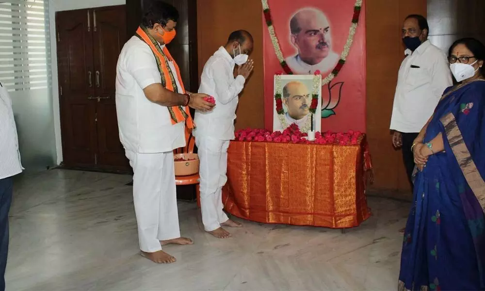 BJP Bandi Sanjay Kumar paying floral tributes to founder of Jana Sangh and todays BJP, Dr Syama Prasad Mukherjee