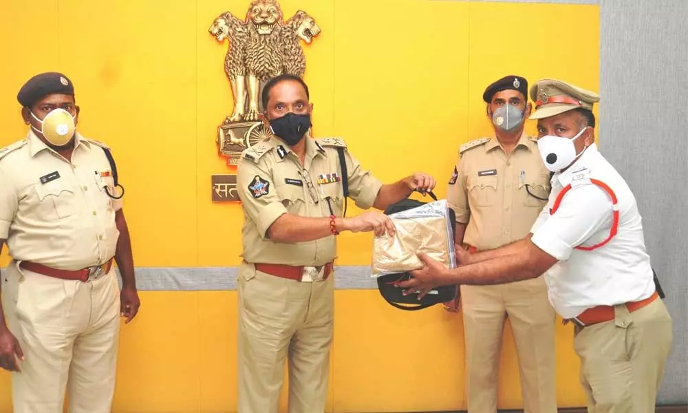Commissioner of Police B Srinivasulu distributing traffic kit bags to the cops in Vijayawada on Monday