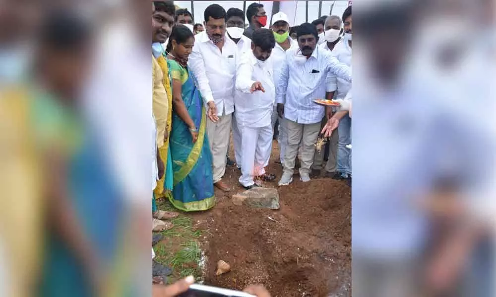 Minister for Energy G Jagadish Reddy laying foundation stone for crop drying platform in the field at Chivvemla mandal on Monday