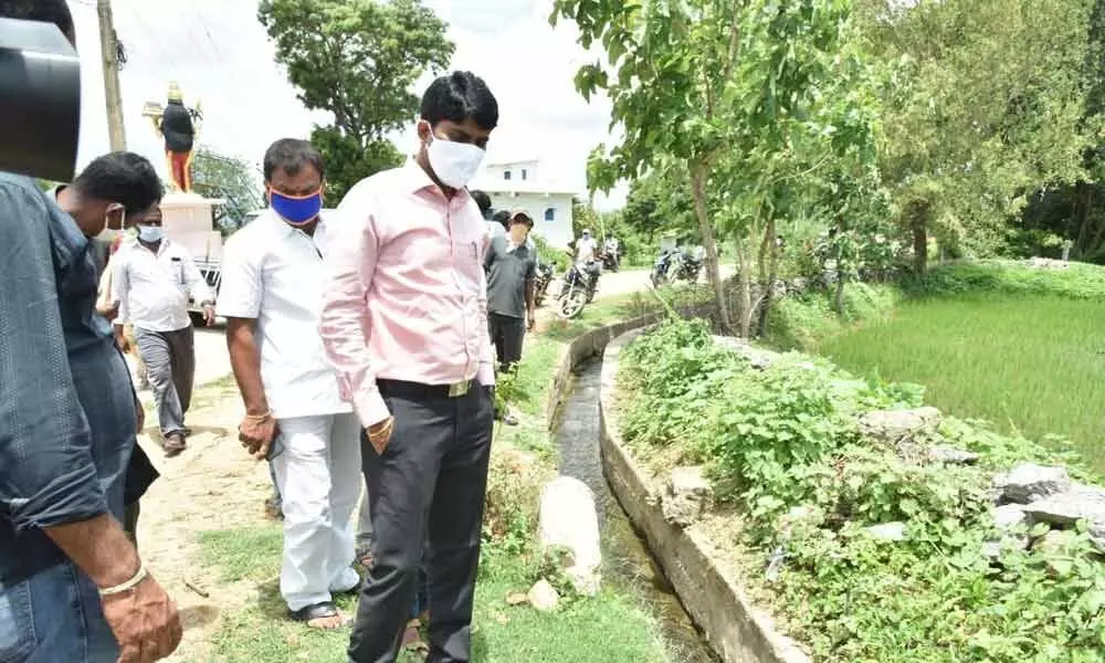 District Collector C Narayana Reddy inspecting a drainage canal in Dubbaka village on Tuesday