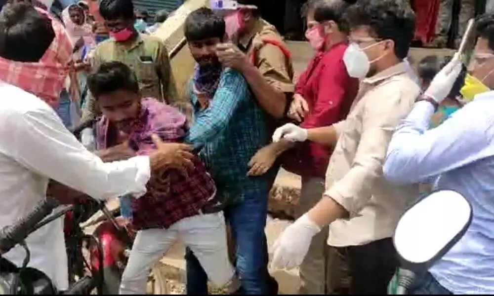 Andhra Bank staff beating a tribal farmer in front of the bank at Yellandu mandal headquarters on Tuesday
