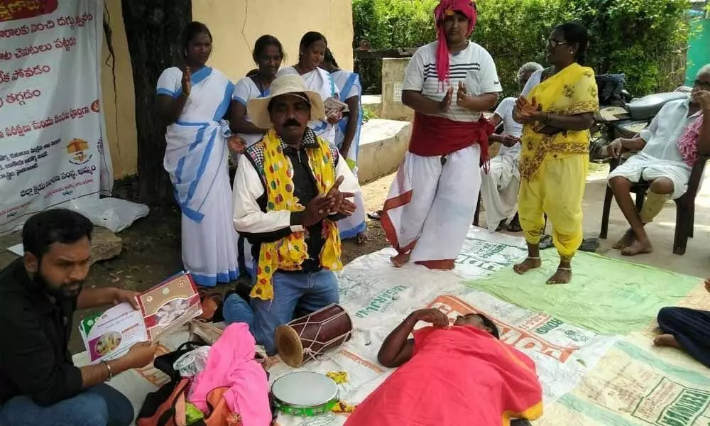 Mimicry and folk artist Kondaiah and his team creating awareness about coronavirus to people in Madhira