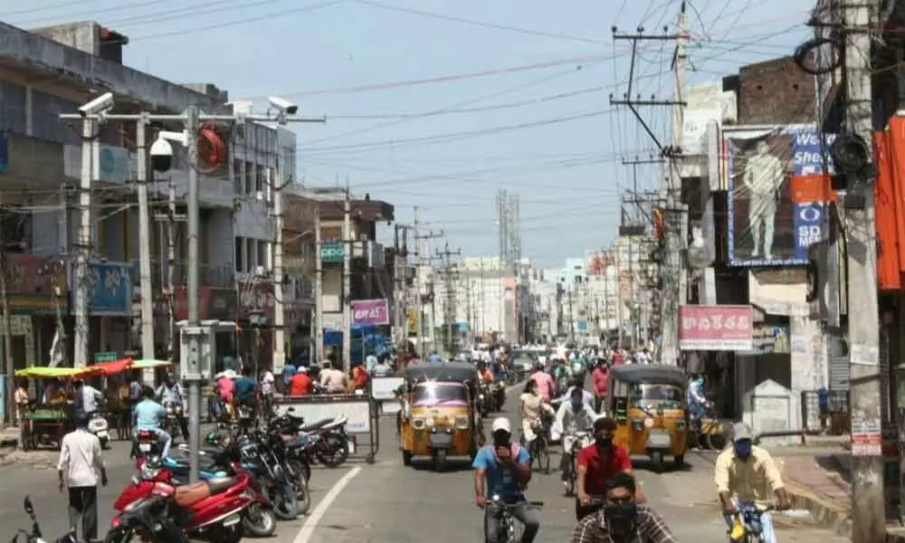 People moving freely even after 1 pm violating the Covid restrictions on G T Road in Srikakulam city on Friday