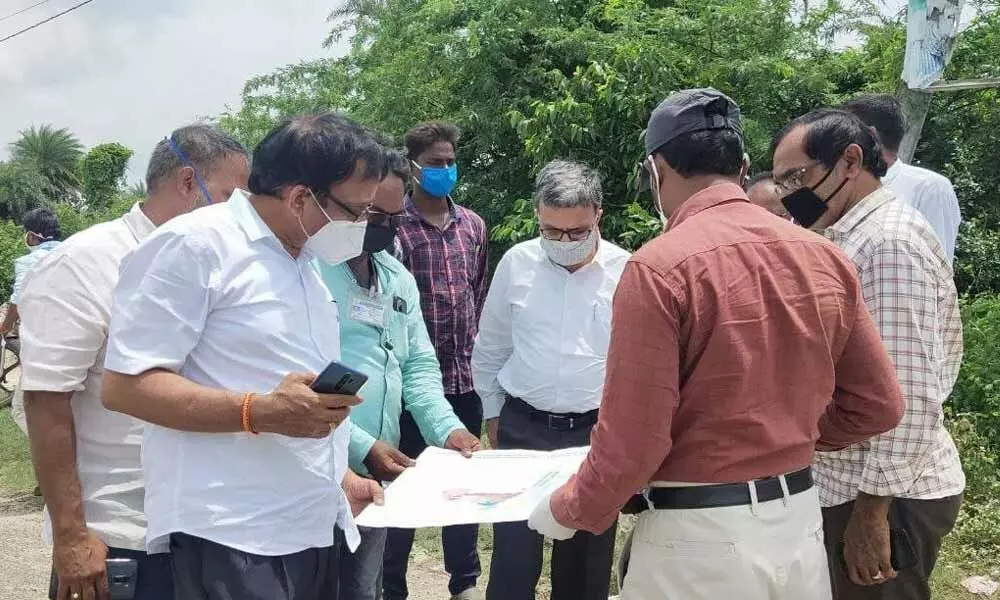 A team of engineers verifying maps regarding proposed sea port lands at Bhavanapadu on Saturday