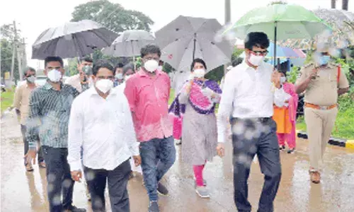 East Godavari District Collector D M Reddy visiting Covid centre at Bommuru with officials in rain on Sunday