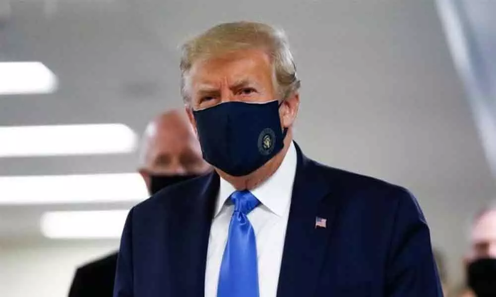 President Donald Trump wears a face mask