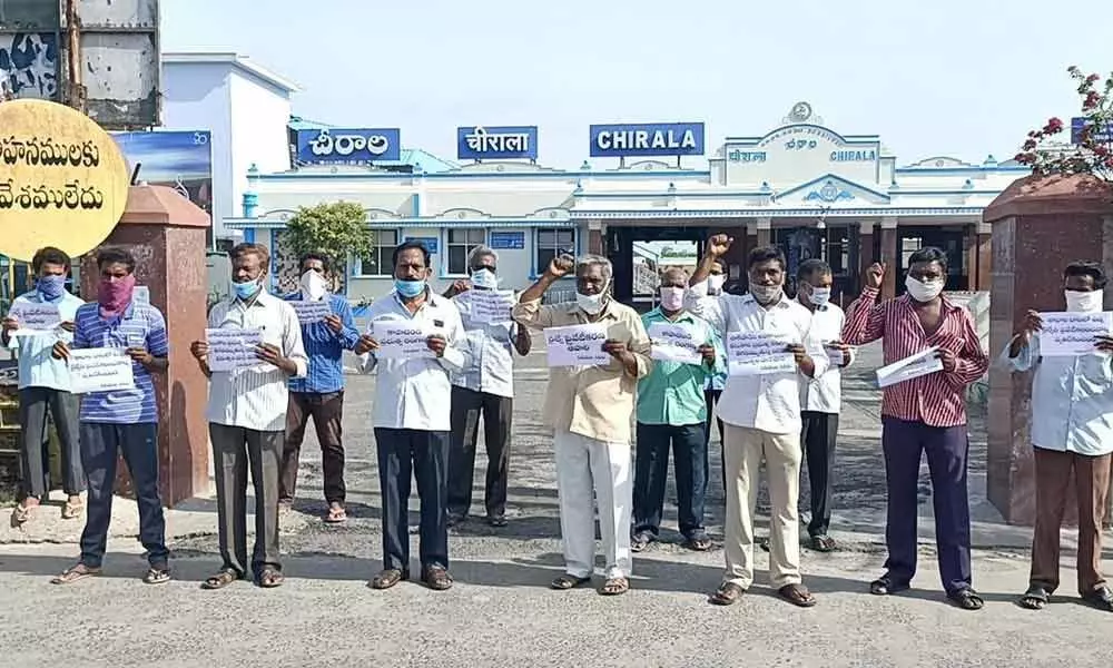 CPI and CPM leaders staging a dharna in front of the railway station in Chirala on Sunday