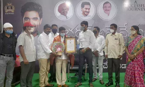 MP Margani Bharat Ram presenting Viswa Guru Book of World Records certificate to Swarnandhra Seva Samsta founder  Dr Gubbala Rambabu at his office in Rajamahendravarm on Wednesday