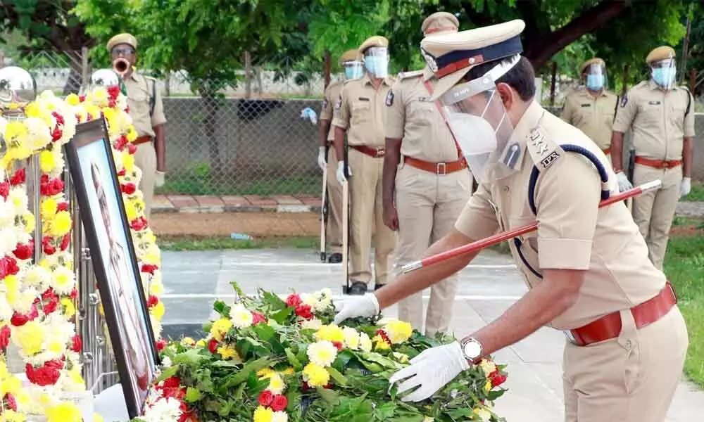 Police officials paying tributes at the portrait of CI Venkateswarlu at Police Parade Grounds in Tirupati on Thursday