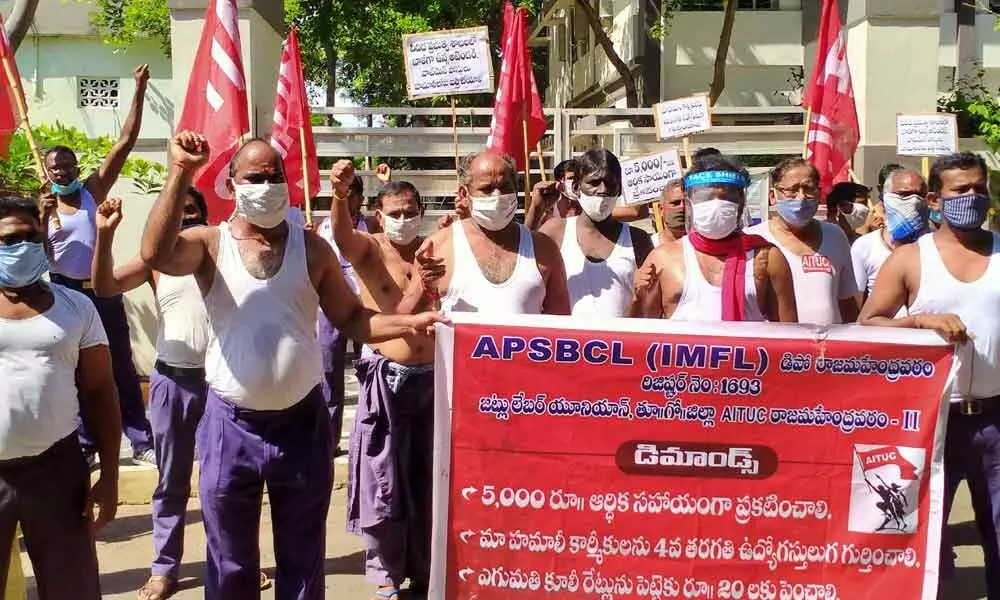 AP Beverages Corporation hamalis staging a dharna in front of Sub-Collectors office in Rajamahendravaram on  Saturday