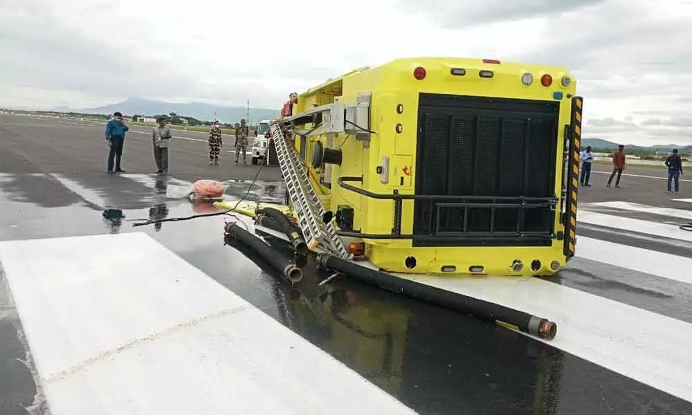 The overturned fire engine on the runway at Tirupati airport