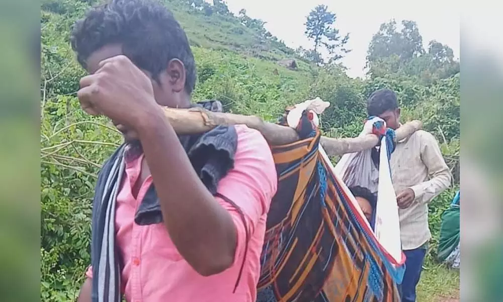 A patient at Hukumpeta mandal being carried on a doli to the nearby hospital for treatment