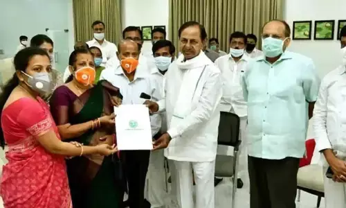 Chief Minister K Chandrashekhar Rao handing over the appointment letter to Santoshi in Hyderabad on Wednesday