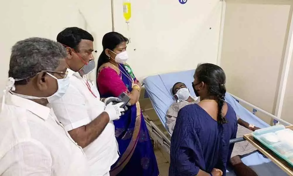 Minister Taneti Vanitha and MLA Jakkampudi Raja consoling the Dalit victim at hospital in Rajamahendravaram on Wednesday
