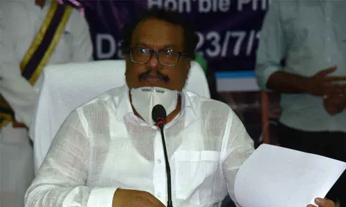 District Collector S Venkat Rao explaining about one lakh saplings’ plantation in Palamuru University, in Mahabubnagar on Thursday