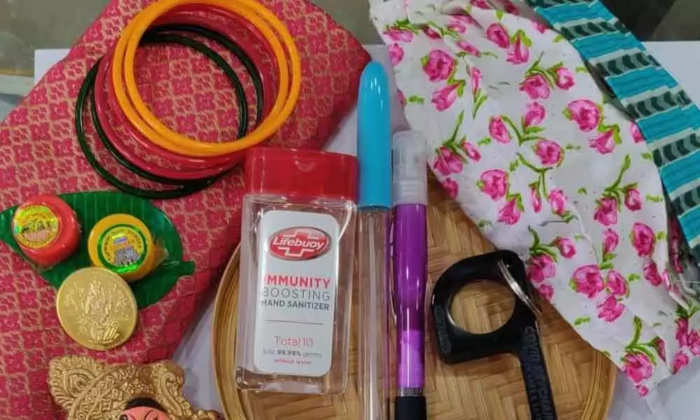 A set of sanitisers, Covid keychain, pen sanitiser and masks that form a part of the thamboolam this Varalakshmi Vratham in Visakhapatnam