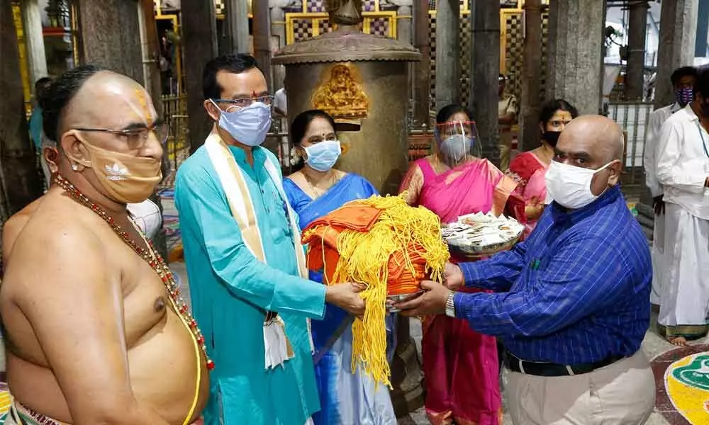 Sri Padmavathi Ammavari Temple staff handing over the Ammavari prasadams to be dispatched to the Postal Department officials  in Tiruchanoor on Friday