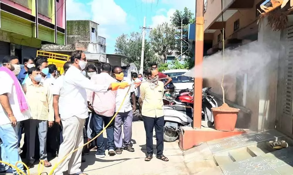 MLA Dr Sanjay Kumar spraying with the sanitation spray machine at 40th ward in Jagtial town on Sunday