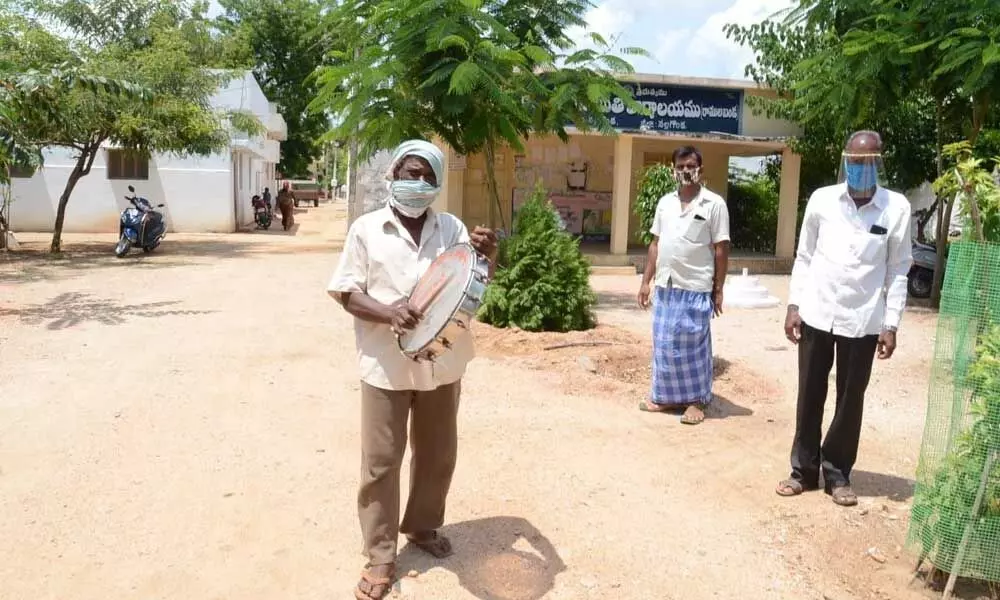 A man announcing the fine for not wearing mask in Ramulabanda village on Tuesday