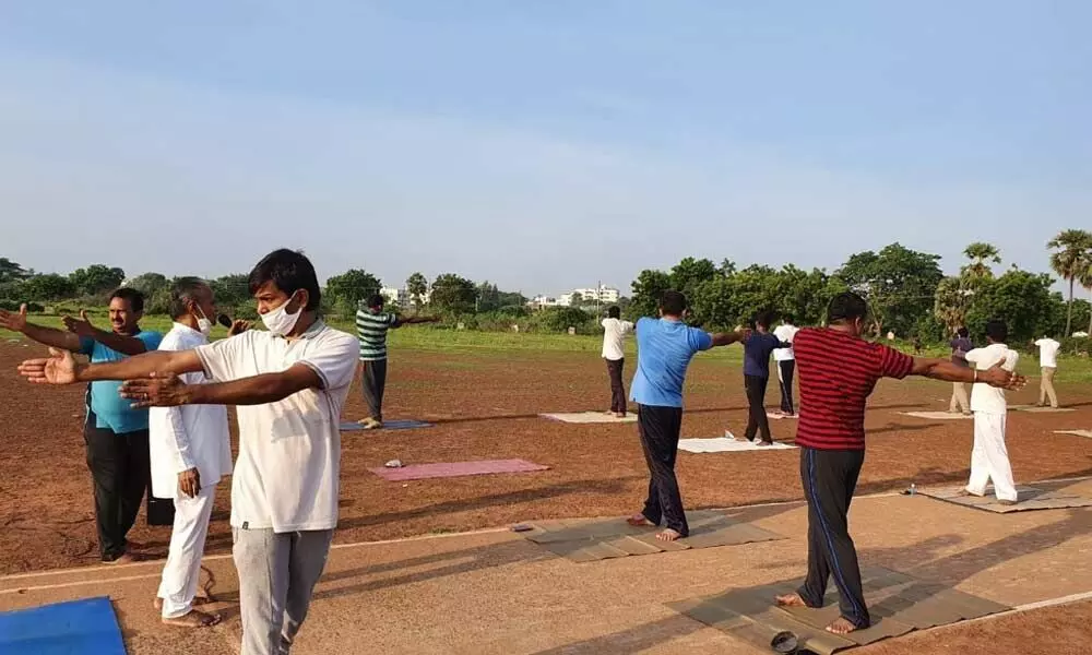 Police staff exposing themselves to sunrays during roll call organised to help them get Vitamin D at an immunity improvement programme