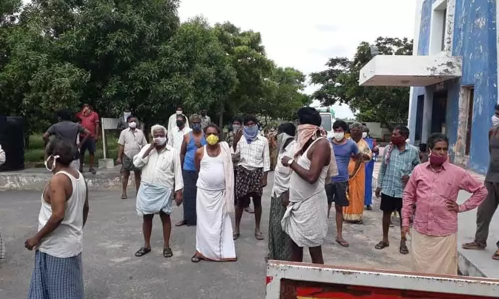 Patients at Vishwabharati Covid Hospital staging a stir on the premises of the hospital at Penchaikalapadu in Kurnool district on Tuesday