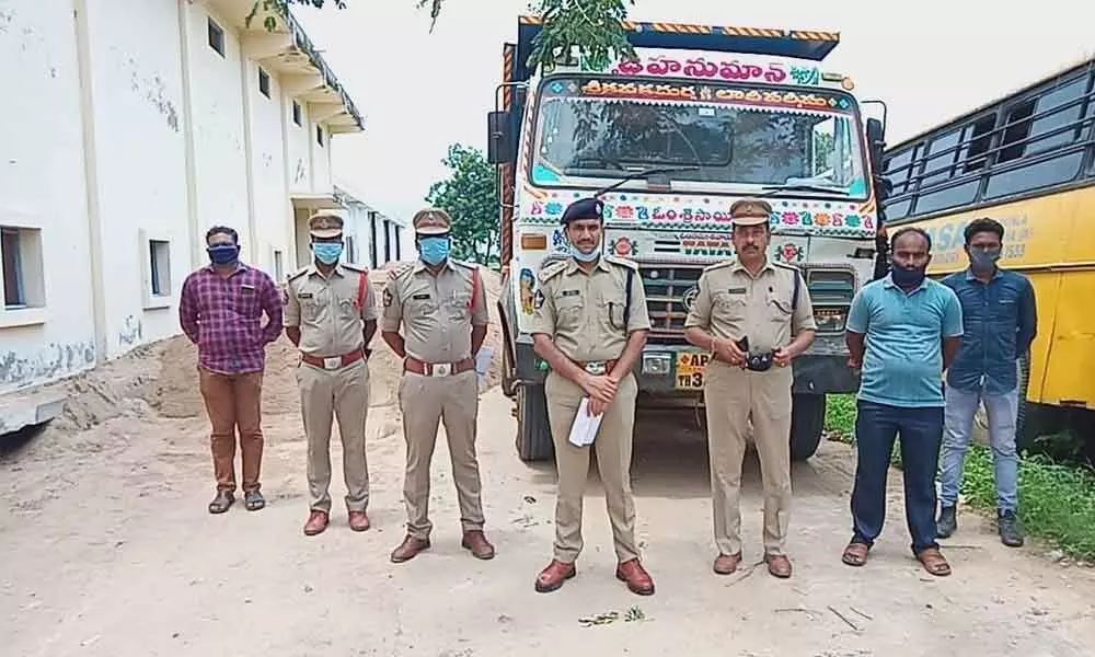 Police officials with sized sand truck in Kanchikacharla on Thursday