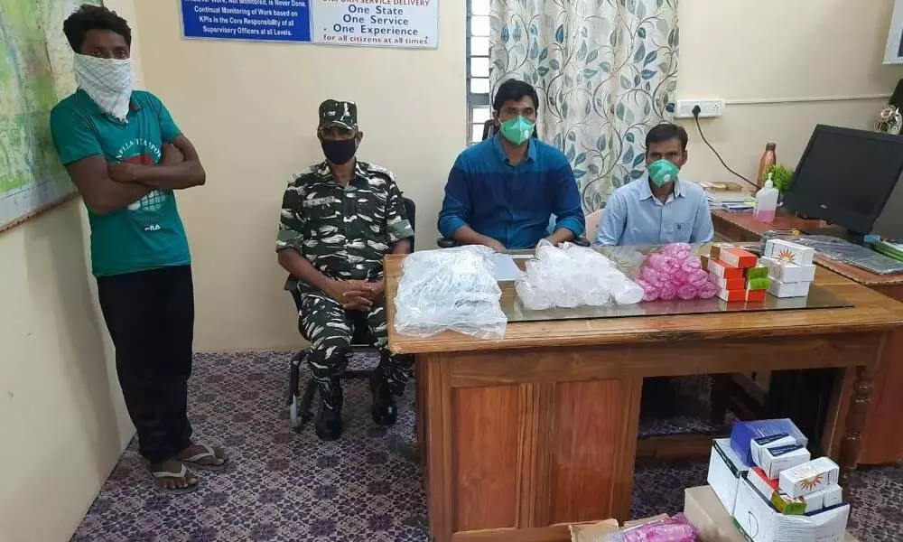 Dummugudem Circle Inspector with the Maoist sympathiser and seized medical kits