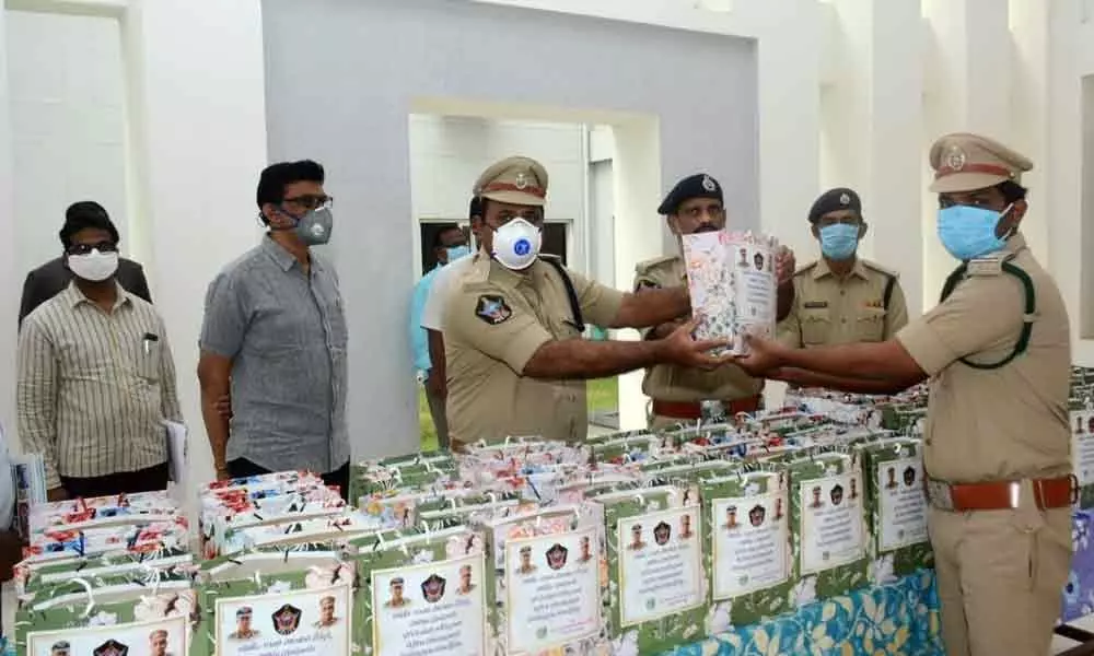 Additional SP K Kumar along with SB DSPs M Ambika Prasad and S Murali Mohan distributing nutritious food to the police personnel at SP office in Kakinada on Friday