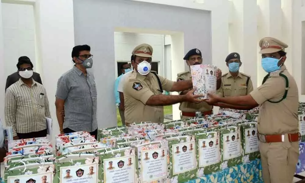 Additional SP K Kumar along with SB DSPs M Ambika Prasad and S Murali Mohan distributing nutritious food to the police personnel at SP office in Kakinada on Friday