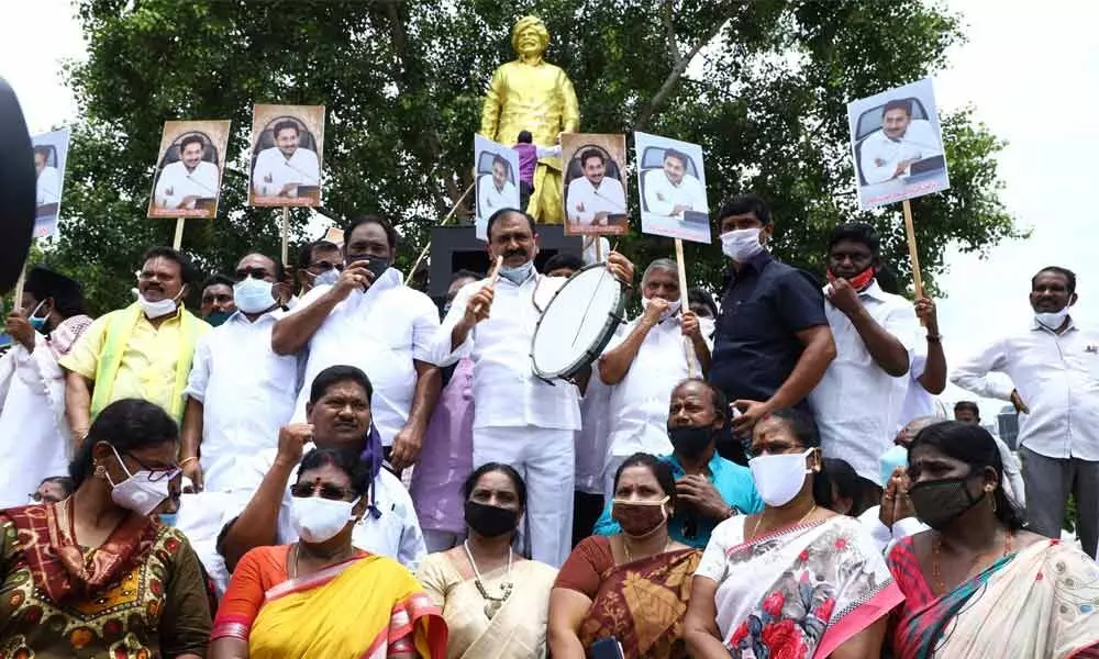 MLA Bhumana Karunakar Reddy playing trumpet in front of Y S Rajasekhara Reddy’s statue