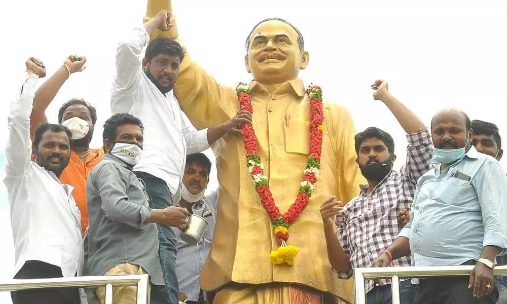 YSRCP leaders performing palabhishekham to the statue of YSR at Gandhi statue centre in Nellore on Saturday
