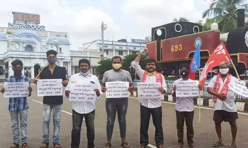 CPI district assistant secretary B Ashok and others staging a dharna against the privatisation of Railways