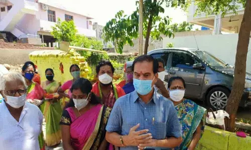 Government Chief Whip D Vinay Bhaskar speaking to locals at Pochamma Temple in Waddepally on Sunday