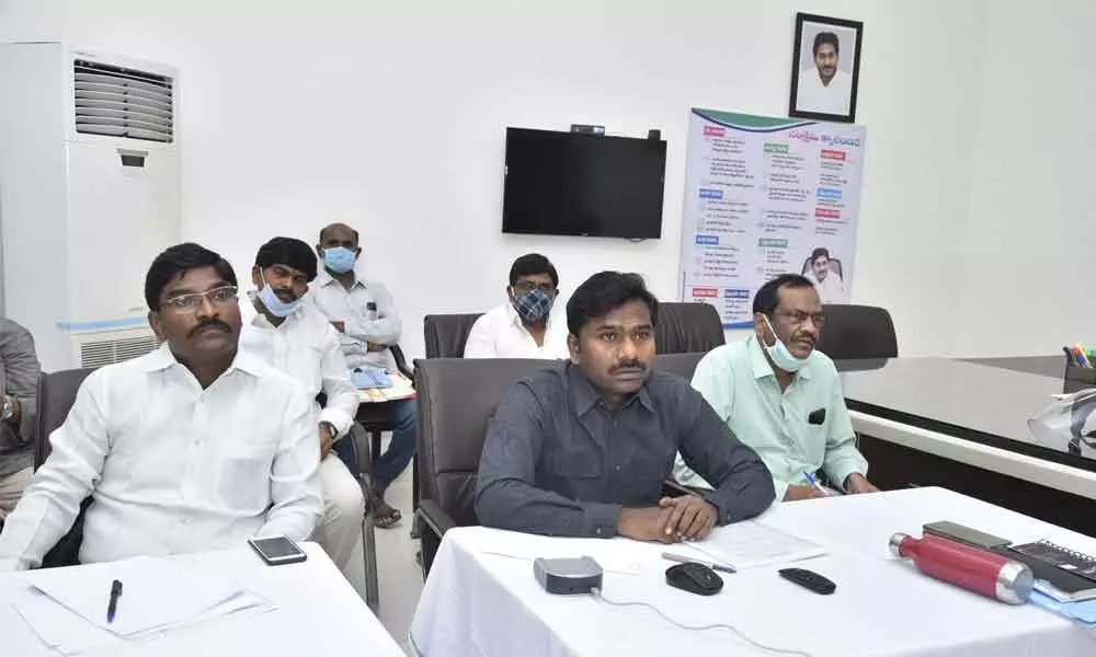 MP Talari Rangaiah and District Collector Gandham Chandrudu speaking at a zoom meeting with industrialists in Anantapur on Sunday