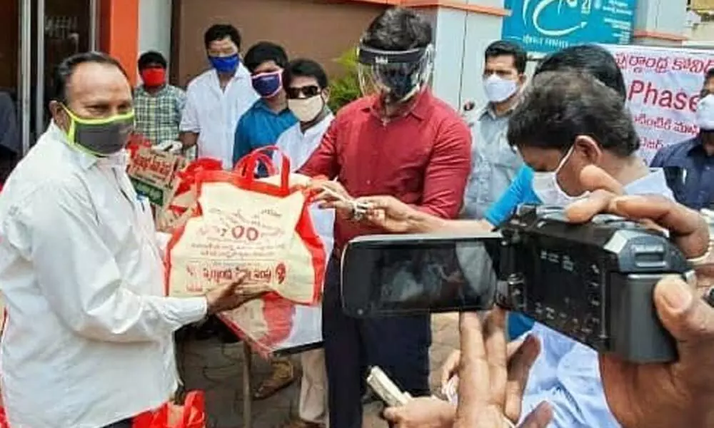 distributing essential commodity kits to cinema workers