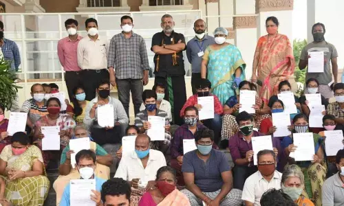 TUDA Chairman Chevireddy Bhaskar Reddy and others with the discharged patients at Sri Padmavati Nilayam Covid care centre