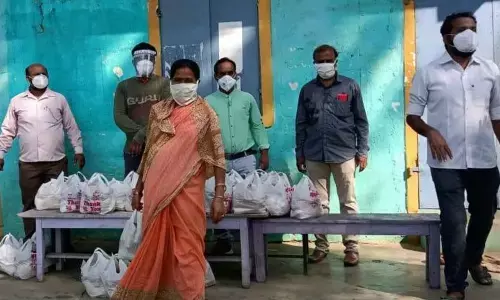 A group of friends distributing essentials to staff of private schools at Palasa-Kasibugga town in Srikakulam district on Tuesday