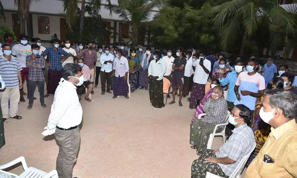 Collector Gandham Chandrudu interacting with inmates of quarantine centre for Covid-19 patients at JNTU-A campus