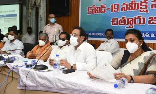 Health Minister Alla Nani conducting a review meeting with district officers on the Covid-19 situation in the district at Senate Hall in SV University