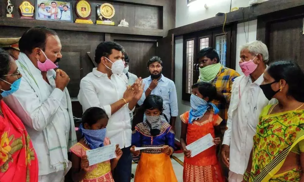 MLA Gadari Kishore Kumar interacting with the girls’ uncle and aunt after handing over FD papers to the girls, at his camp office in Tirumalagiri