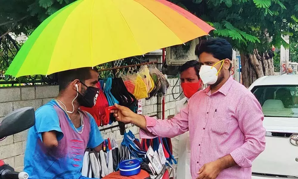 A roadside vendor selling masks and sanitisers at Municipal Office Circle in Tirupati