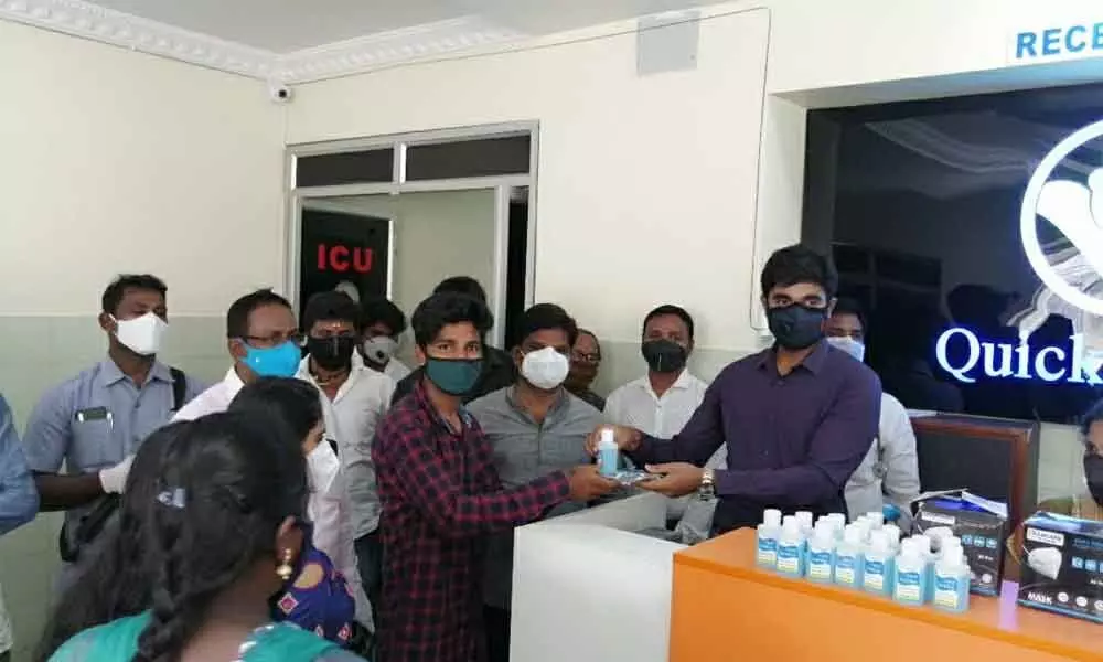 MP Margani Bharat giving away sanitisers after inaugurating Quick n Care 24 hours hospital in Rajamahendravaram on Thursday